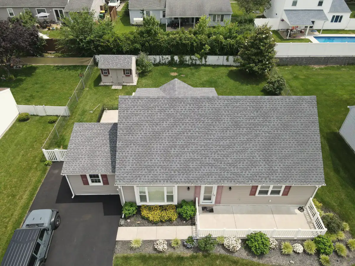 A gray asphalt shingle roof on a suburban house seen from above