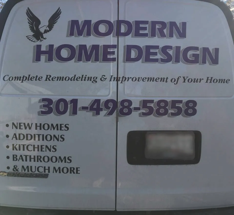 The back doors of the Modern Home Design van with the eagle, the name and the phone number 301-498-5858